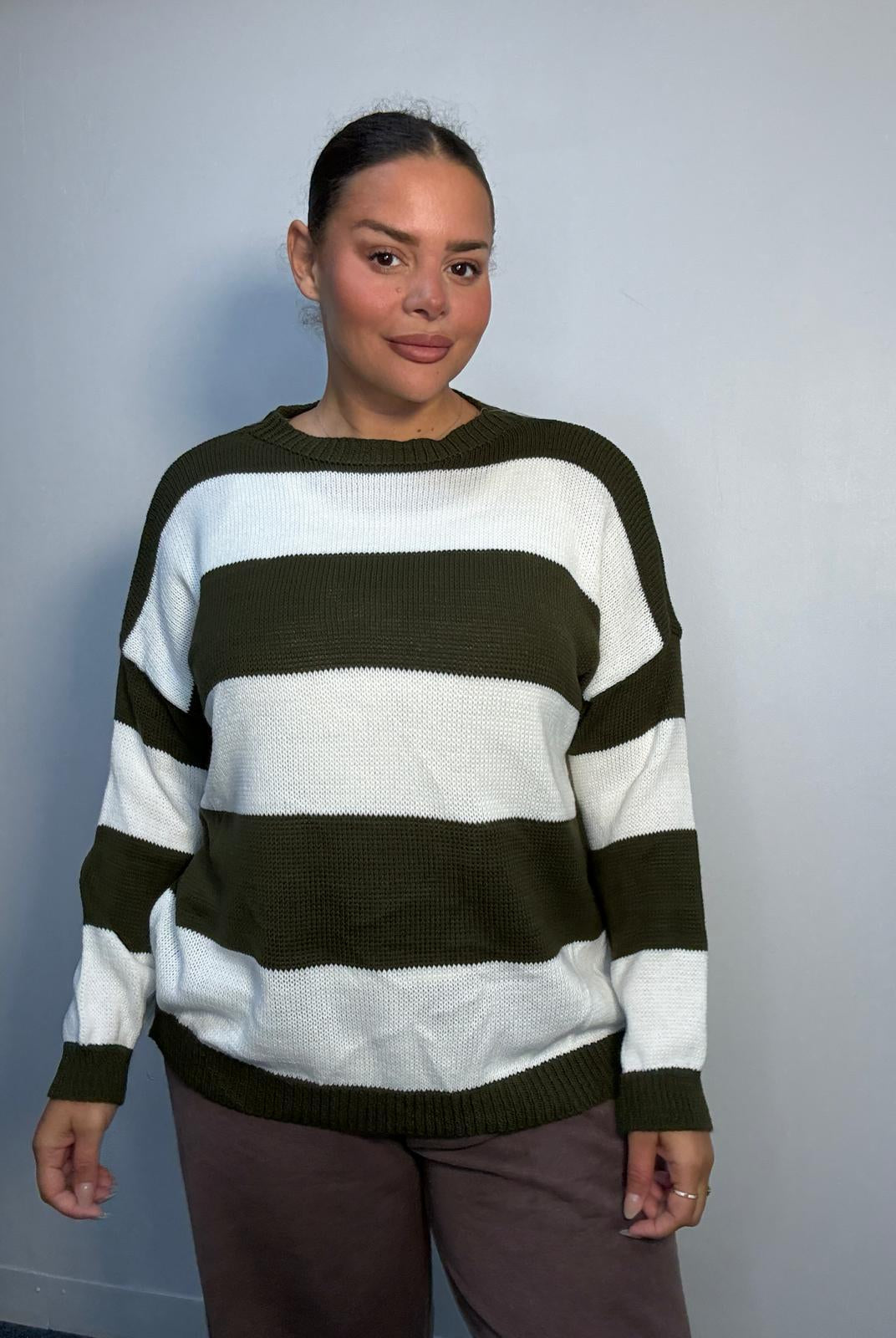 Plus-size model wearing a khaki green and white horizontally striped knitted jumper with round neckline, long sleeves and ribbed trims.