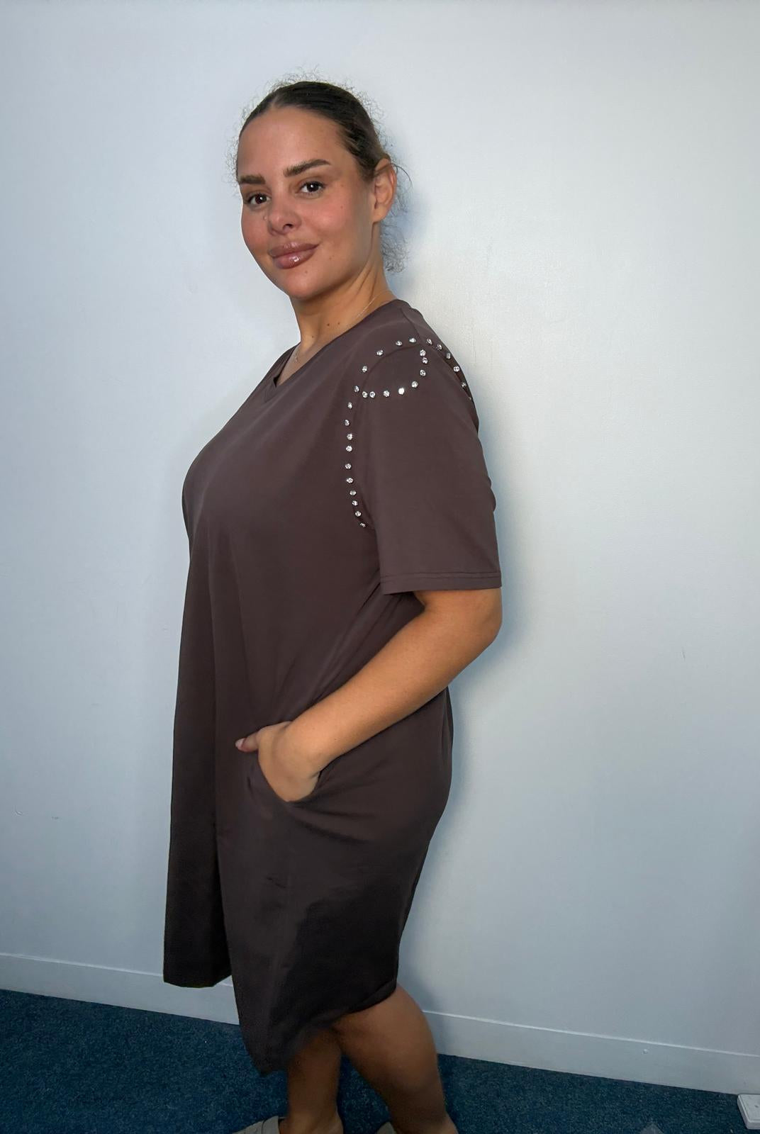 Side view of a chocolate brown plus-size midi dress featuring diamante-style shoulder detailing, short sleeves and side pocket.