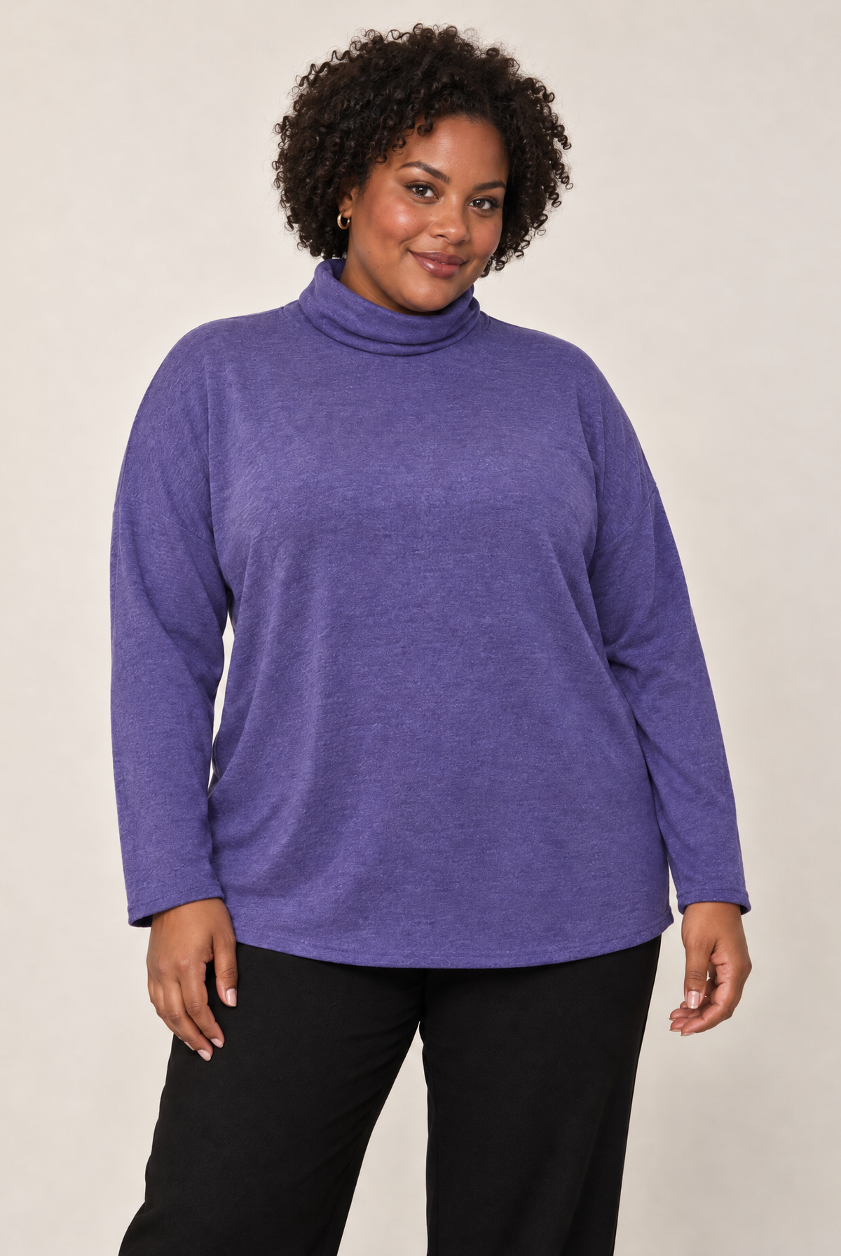 Plus-size model wearing a purple cowl neck long sleeve top with a relaxed fit.