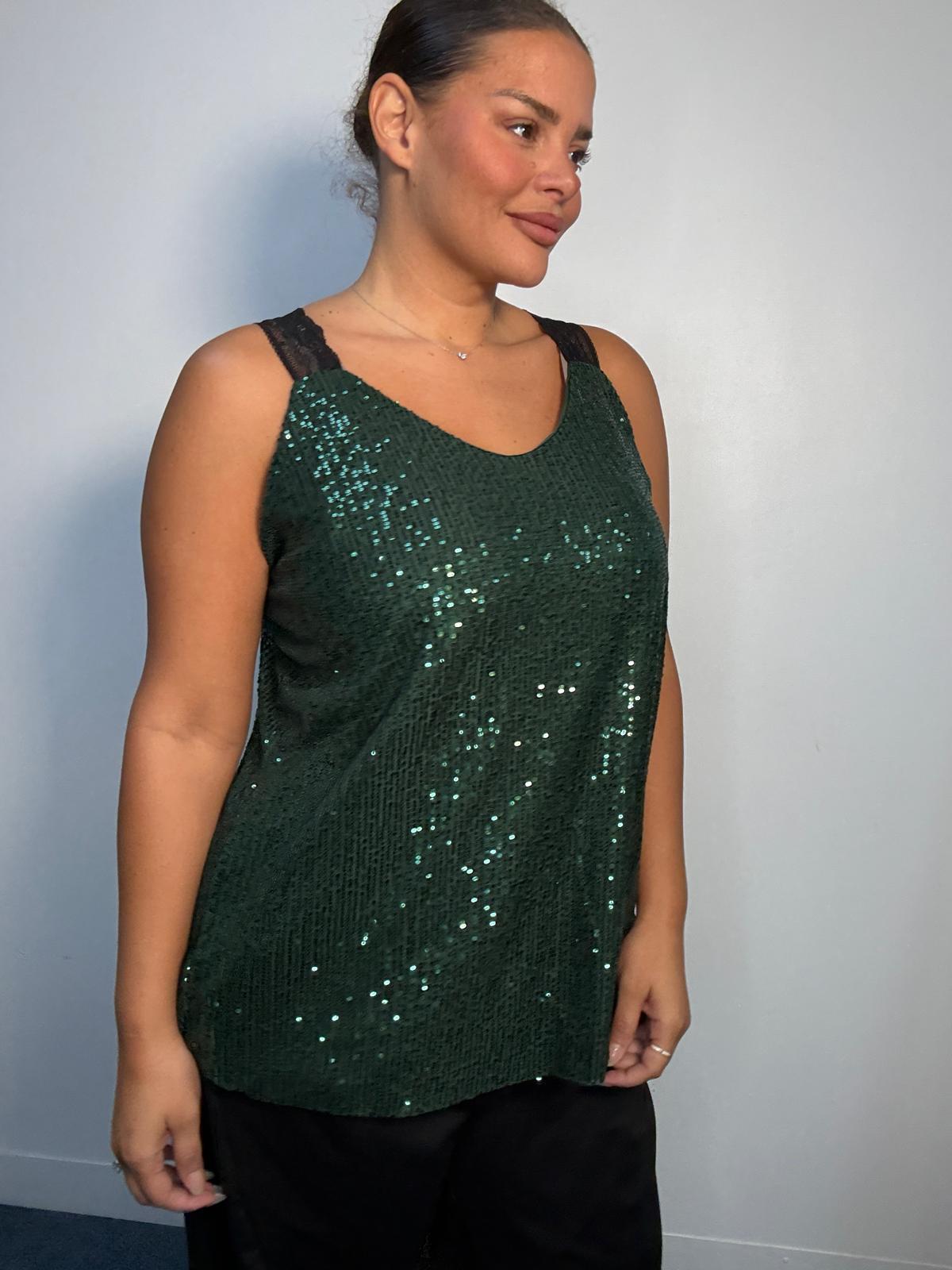 Side view green sequin embellishments and contrasting black shoulder straps on a plus-size partywear cami top.