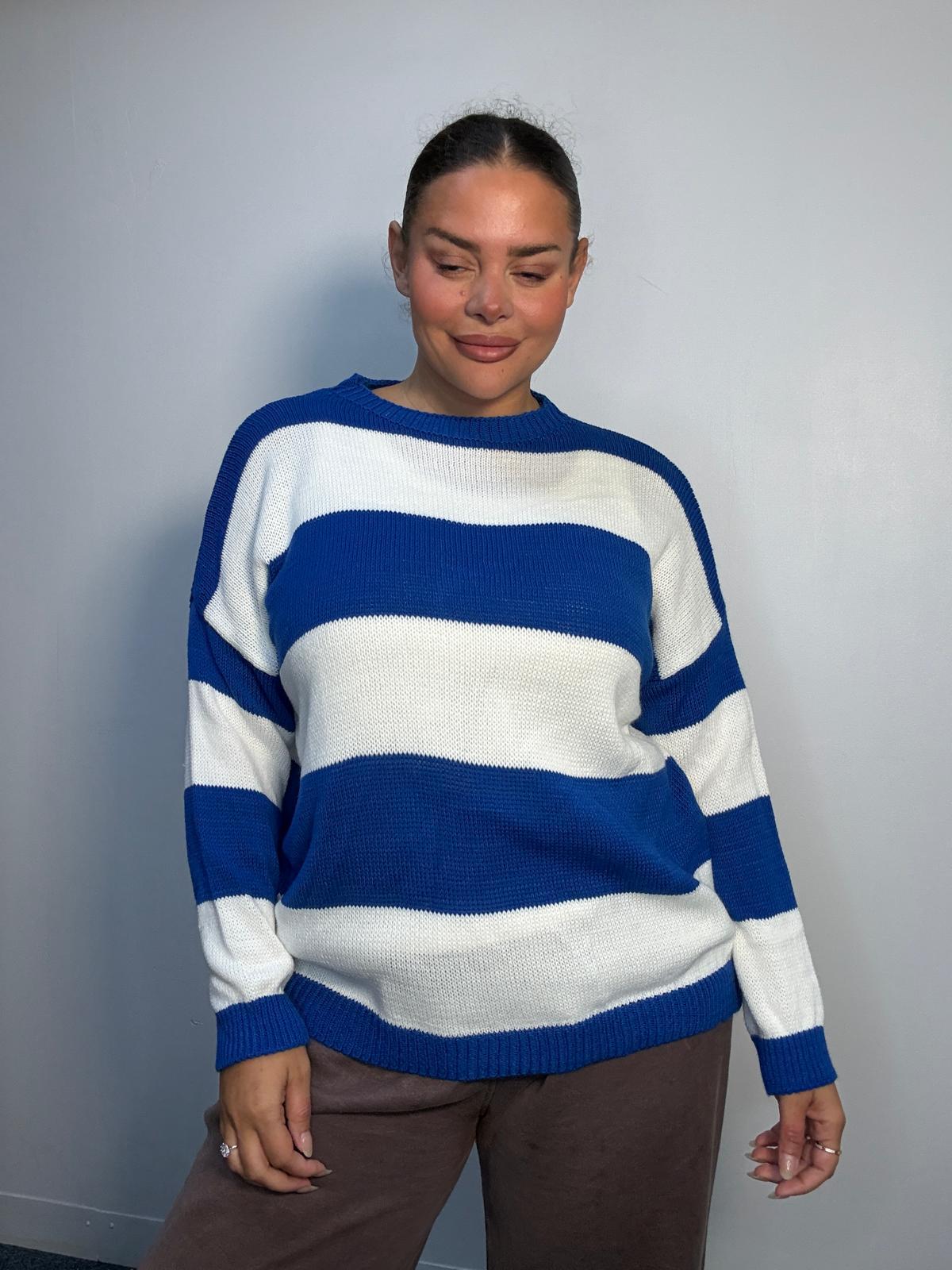 Plus-size model wearing a royal blue and white horizontally striped knitted jumper with round neckline, long sleeves and ribbed trims.