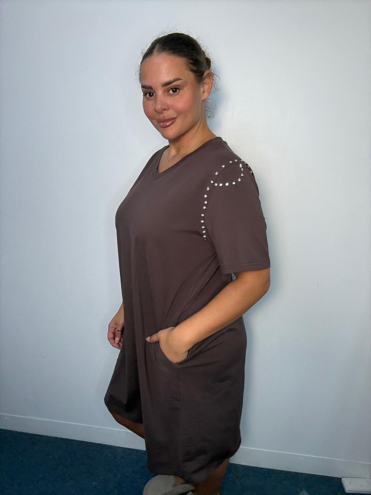 Side view of a chocolate brown plus-size midi dress featuring diamante-style shoulder detailing, short sleeves and side pocket.