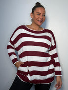 Plus Size Model wearing burgundy and white striped jumper showing the jumper from the front