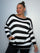 Plus Size Model wearing black and white striped jumper showing the jumper from the front
